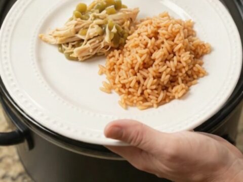 Slow cooker salsa verde chicken with melted Oaxaca cheese, served over Spanish rice