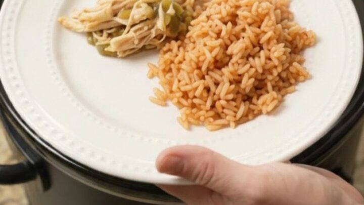 Slow cooker salsa verde chicken with melted Oaxaca cheese, served over Spanish rice