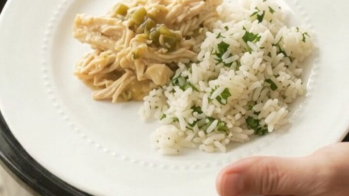 Shredded chicken in creamy salsa verde sauce with melted cheddar, served in a slow cooker