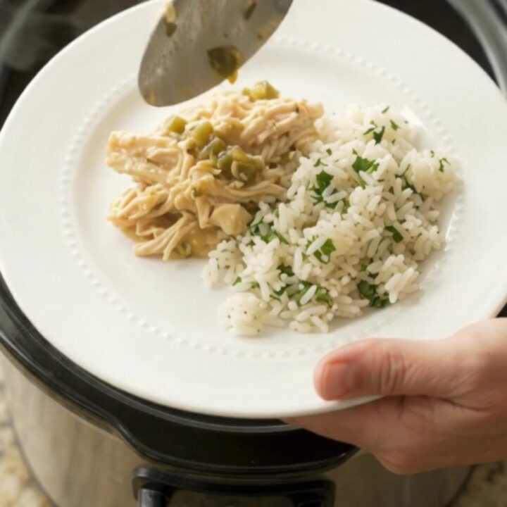 Shredded chicken in creamy salsa verde sauce with melted cheddar, served in a slow cooker