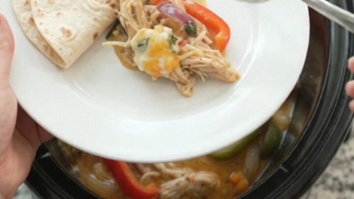Creamy Crockpot fajita chicken with shredded chicken, peppers, and onions in a creamy sauce