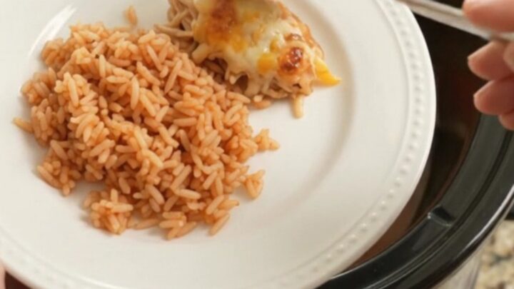 Slow cooker filled with shredded chicken, peppers, and melted Oaxaca cheese