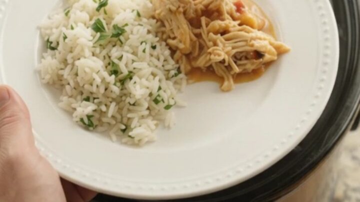 Slow cooker fiesta chicken with creamy chipotle pineapple sauce, topped with melted cheddar