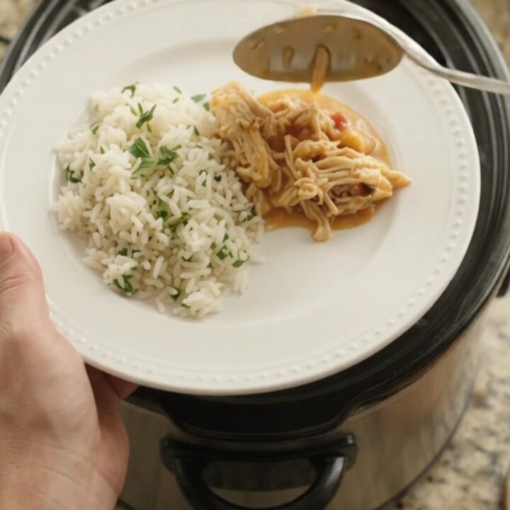 Slow cooker fiesta chicken with creamy chipotle pineapple sauce, topped with melted cheddar