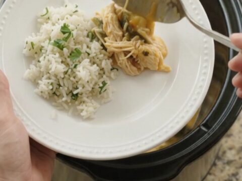 Shredded chicken, hominy, and roasted poblanos in a creamy cheese sauce in a slow cooker.