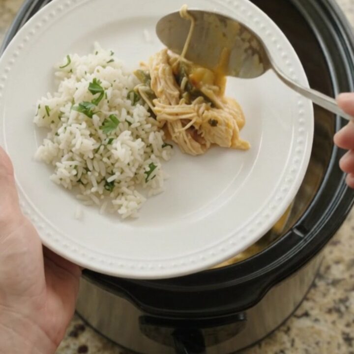Shredded chicken, hominy, and roasted poblanos in a creamy cheese sauce in a slow cooker.
