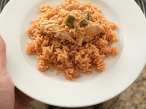 Shredded chipotle pineapple chicken with melted Oaxaca cheese in a slow cooker