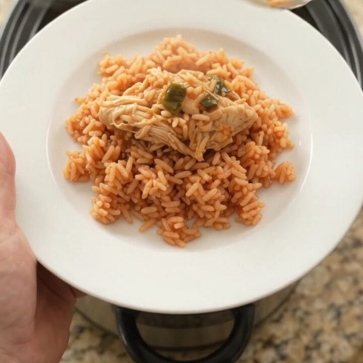 Shredded chipotle pineapple chicken with melted Oaxaca cheese in a slow cooker
