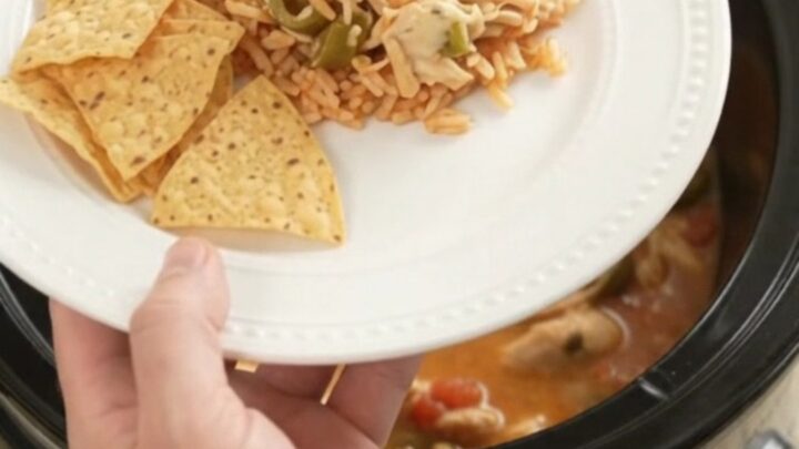 Shredded fiesta chicken in a creamy pepper jack and queso sauce in a slow cooker