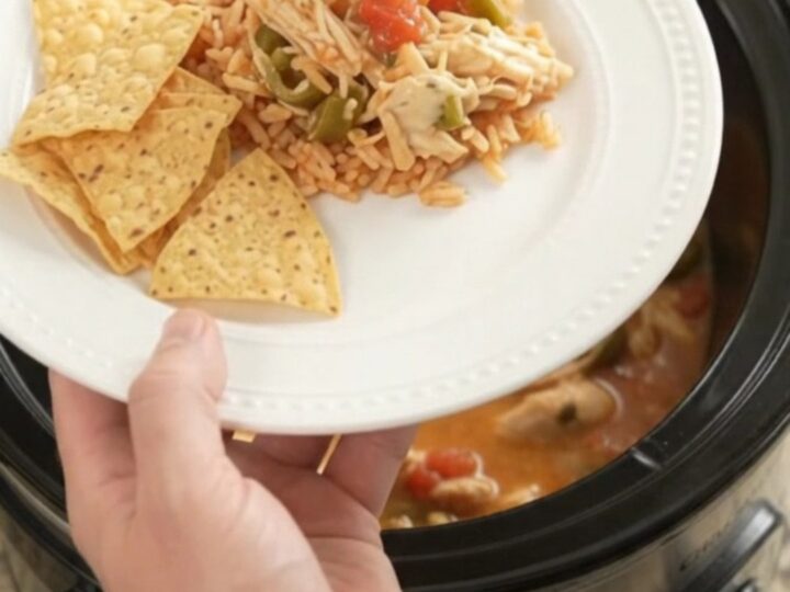Shredded fiesta chicken in a creamy pepper jack and queso sauce in a slow cooker