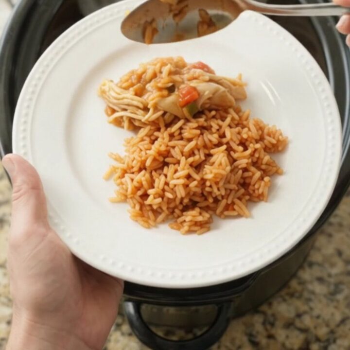 Shredded fiesta chicken with melted Oaxaca cheese in a slow cooker