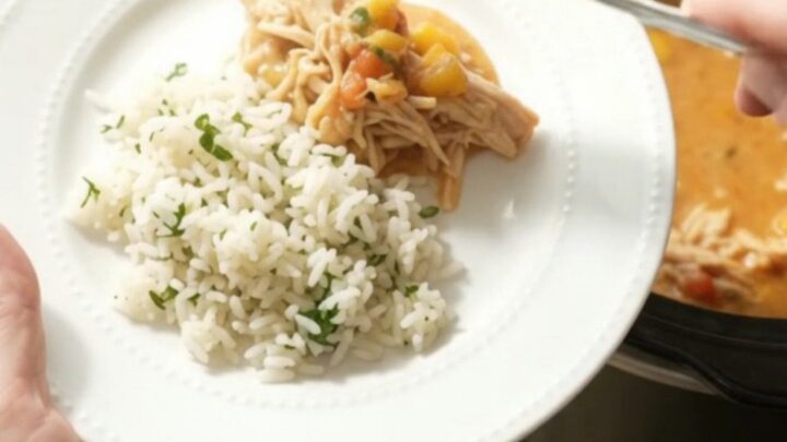 Slow cooker fiesta chicken with creamy cheddar and mango, served in a black crockpot