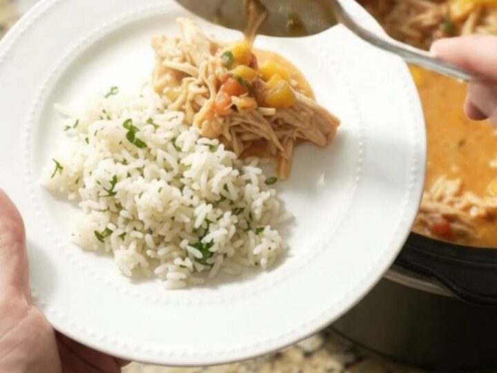 Slow cooker fiesta chicken with creamy cheddar and mango, served in a black crockpot
