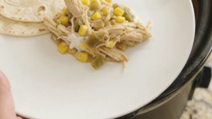 Slow-cooker fiesta chicken with creamy sauce and melted cheese, ready to serve