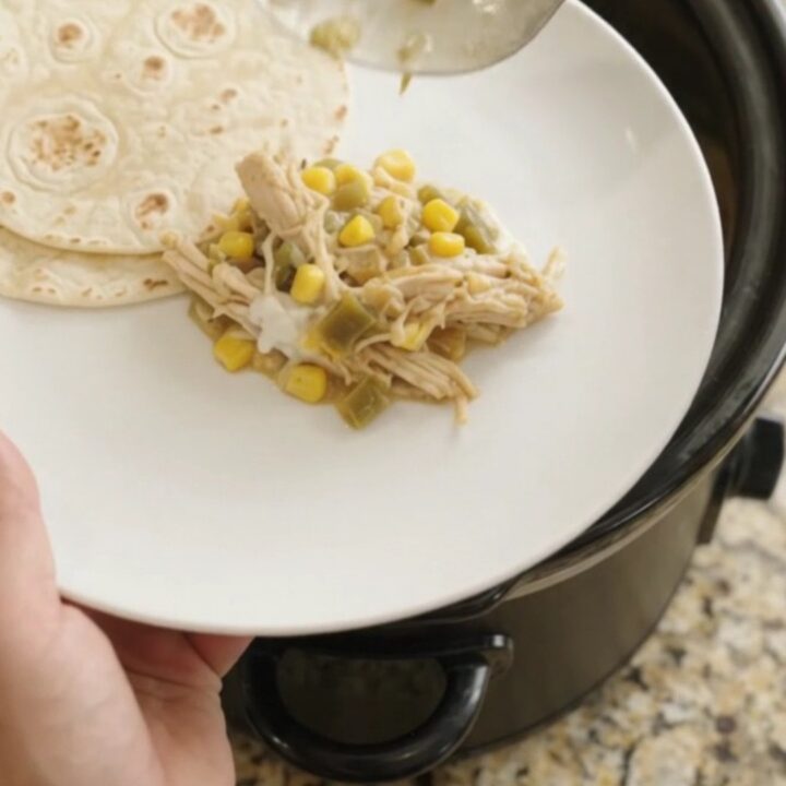 Slow-cooker fiesta chicken with creamy sauce and melted cheese, ready to serve