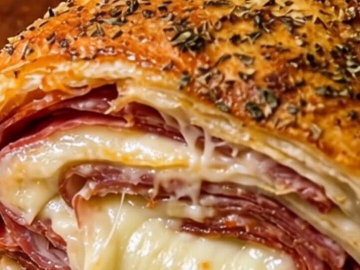 A golden-brown, crispy Italian stromboli cut into thick slices