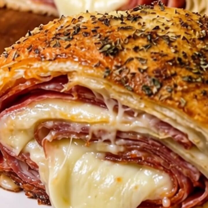 A golden-brown, crispy Italian stromboli cut into thick slices