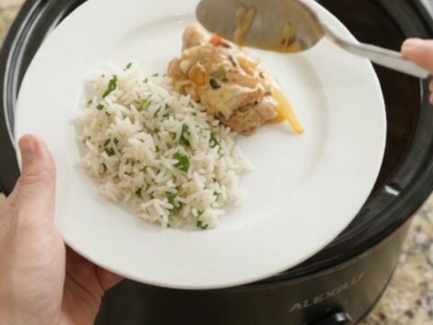 Slow cooker chicken thighs with peppers and onions in creamy cheddar sauce