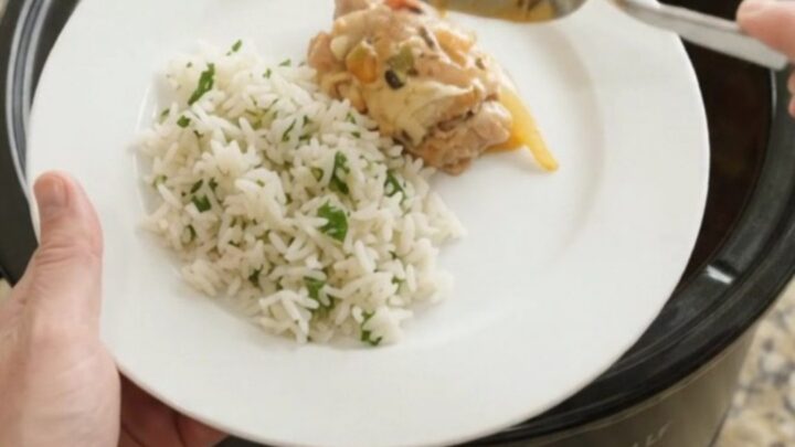 Slow cooker chicken thighs with peppers and onions in creamy cheddar sauce