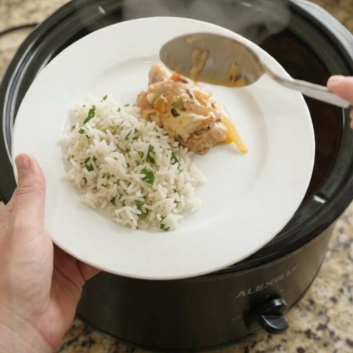 Slow cooker chicken thighs with peppers and onions in creamy cheddar sauce