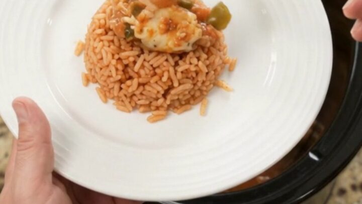 Slow cooker filled with shredded chicken in a cheesy tomato-jalapeño sauce, topped with melted Oaxaca cheese.