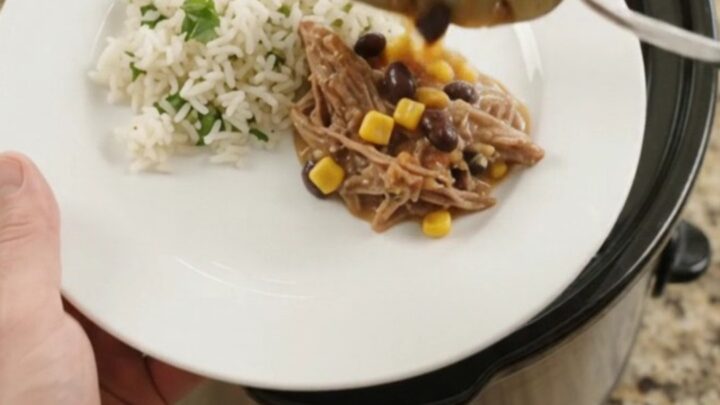 Slow cooker beef barbacoa with black beans, corn, and melted cheese sauce