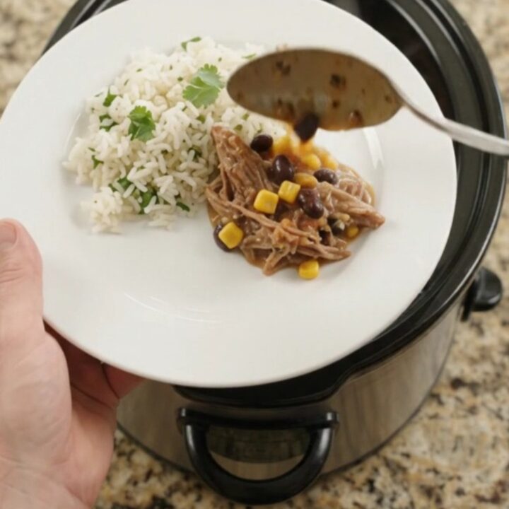 Slow cooker beef barbacoa with black beans, corn, and melted cheese sauce