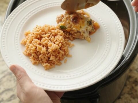 Slow cooker filled with tender chicken thighs, melted cheese, and mango habanero sauce