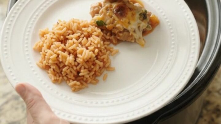 Slow cooker filled with tender chicken thighs, melted cheese, and mango habanero sauce