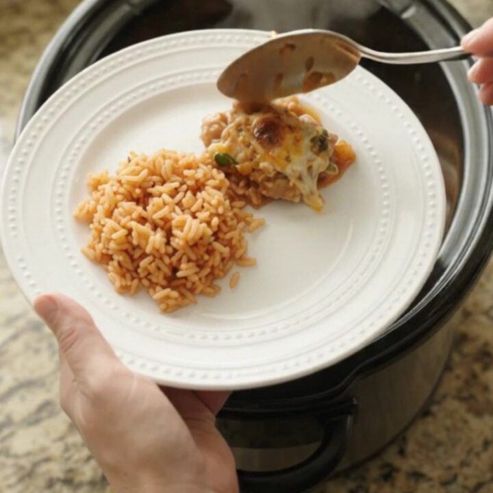 Slow cooker filled with tender chicken thighs, melted cheese, and mango habanero sauce