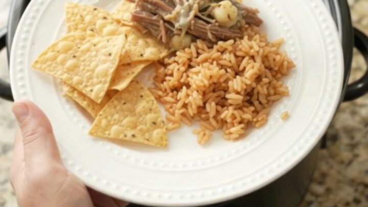 Shredded beef barbacoa with poblano and hominy in creamy queso sauce in a slow cooker