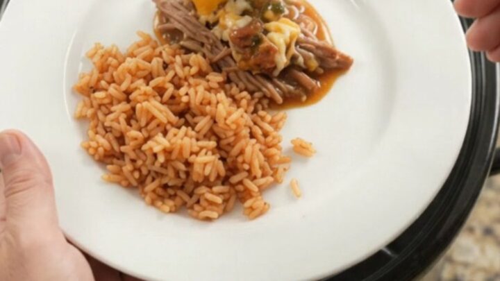 A slow cooker filled with shredded beef barbacoa, blistered cheese, and a glossy mango-habanero glaze.