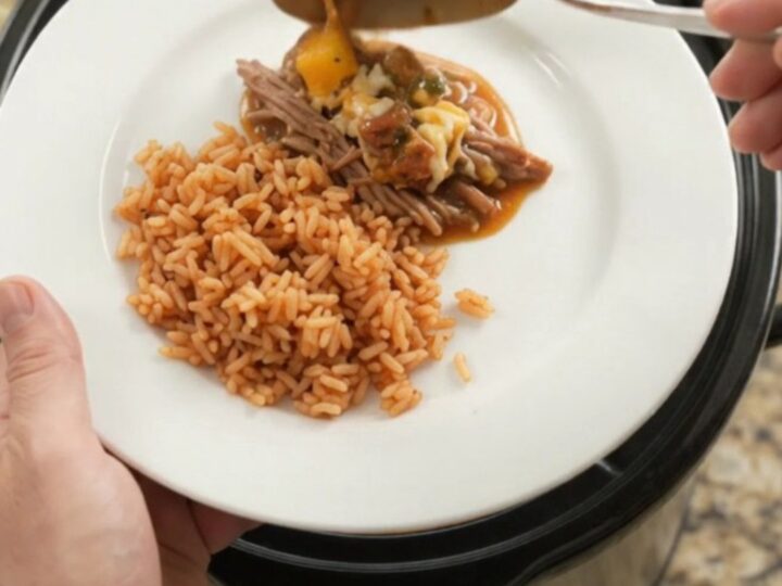A slow cooker filled with shredded beef barbacoa, blistered cheese, and a glossy mango-habanero glaze.