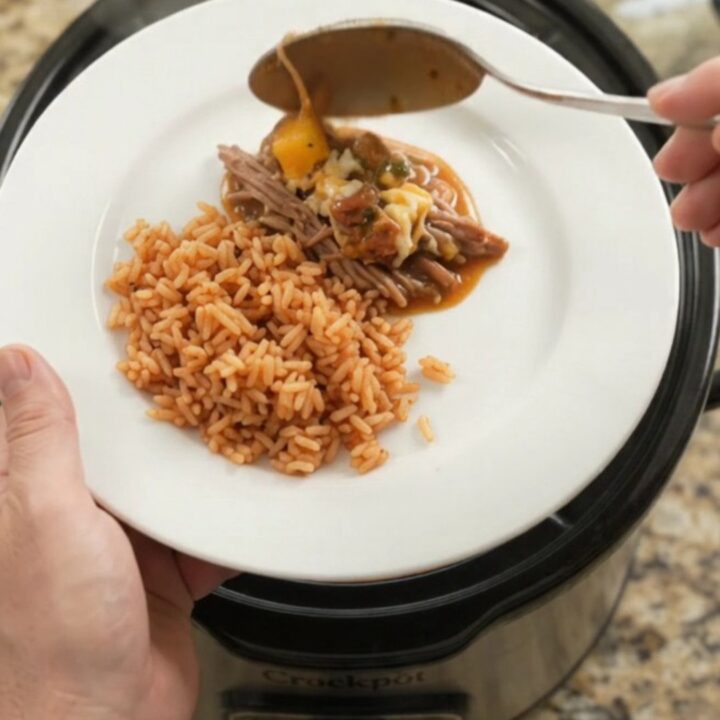 A slow cooker filled with shredded beef barbacoa, blistered cheese, and a glossy mango-habanero glaze.