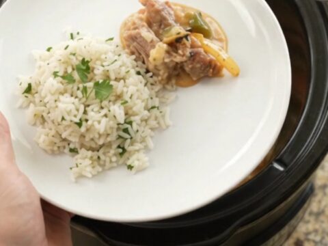 Slow cooker cheddar fajita pork carnitas with peppers and onions in a creamy sauce