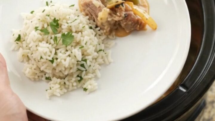Slow cooker cheddar fajita pork carnitas with peppers and onions in a creamy sauce