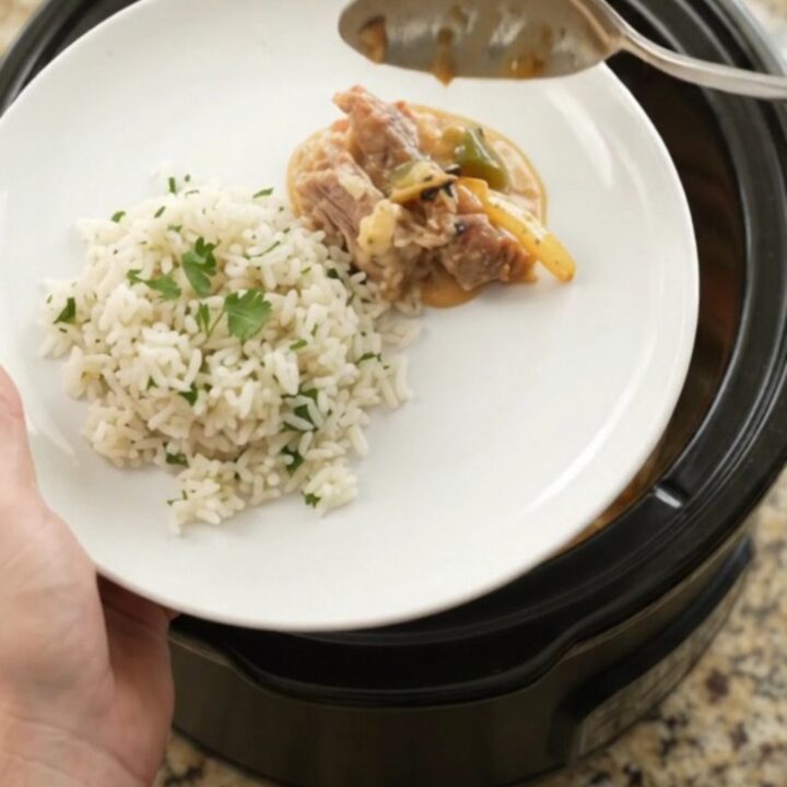Slow cooker cheddar fajita pork carnitas with peppers and onions in a creamy sauce