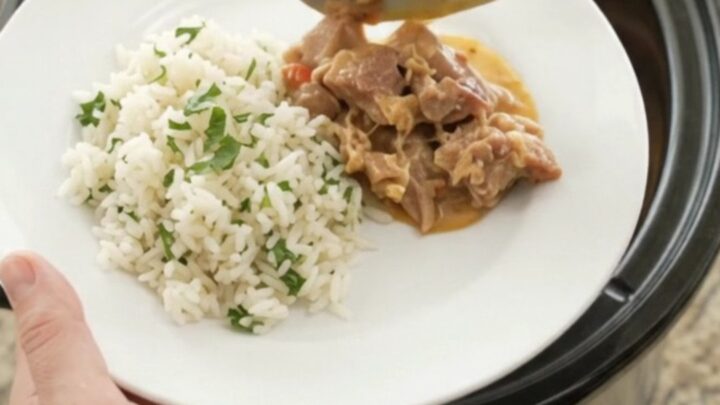 Crockpot full of creamy chipotle pineapple pork carnitas with melted cheese