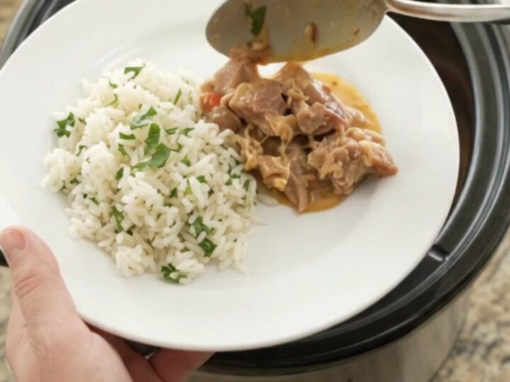 Crockpot full of creamy chipotle pineapple pork carnitas with melted cheese