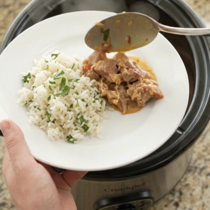 Crockpot full of creamy chipotle pineapple pork carnitas with melted cheese