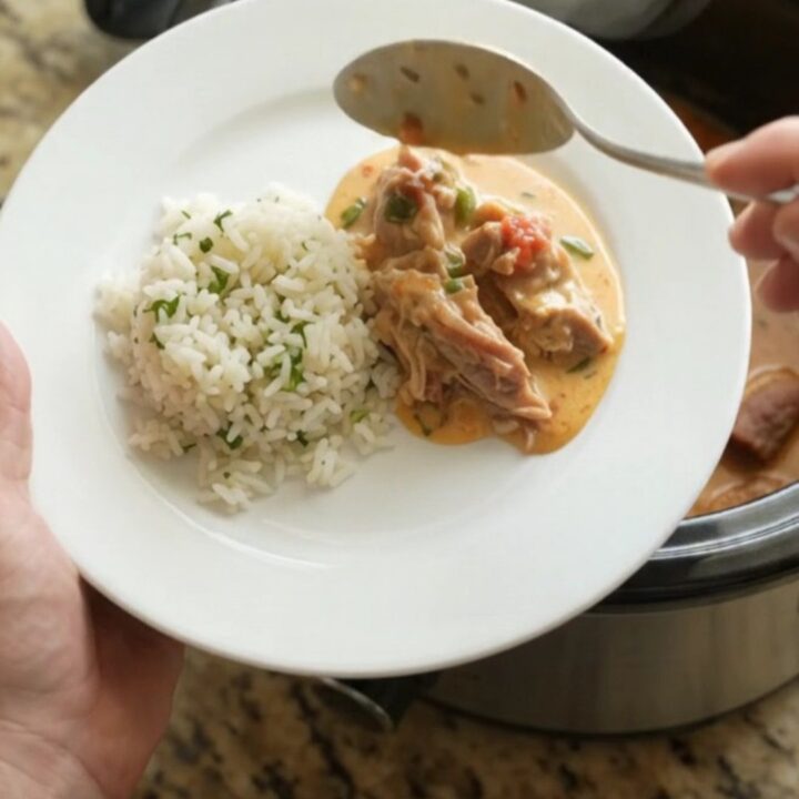 Slow cooker filled with creamy pork carnitas, topped with melted cheddar and jalapeños.