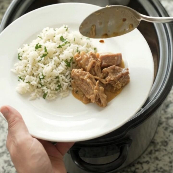 Crockpot full of creamy cheddar taco pork carnitas with pinto beans and melted cheese sauce