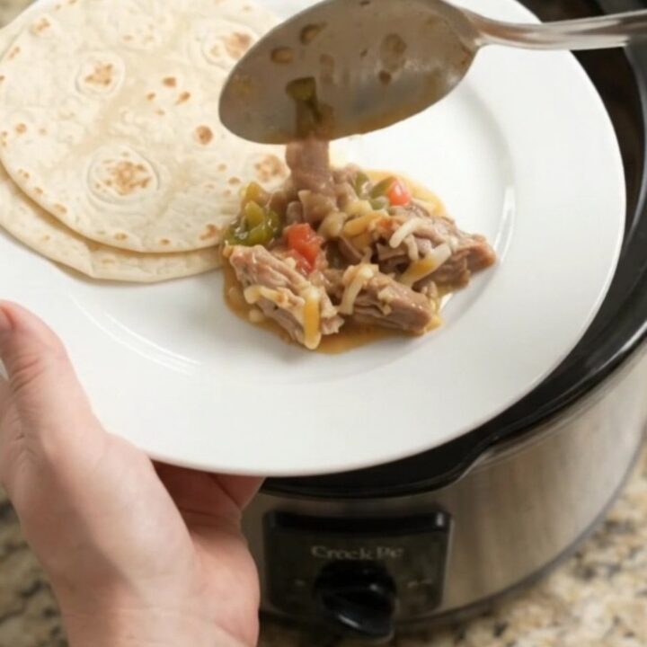 Slow cooker pork carnitas with creamy tomato-jalapeño sauce and melted Monterey Jack cheese.