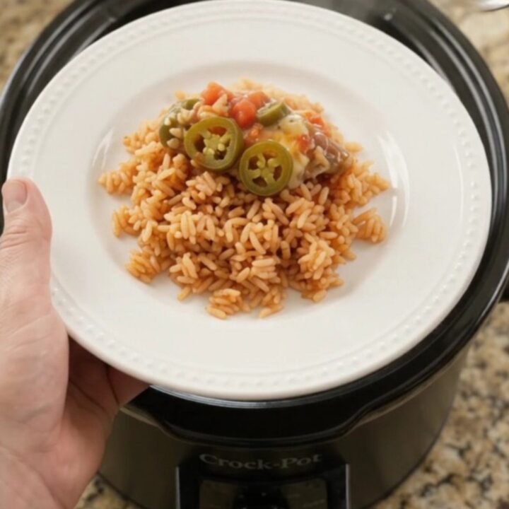 Bubbling slow-cooker pork carnitas with melted Oaxaca cheese and tomato-jalapeño sauce, topped with pickled jalapeños