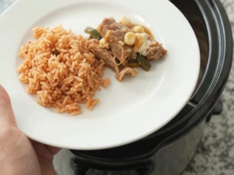 Slow cooker pork carnitas with melted Oaxaca cheese, hominy, and roasted poblanos.