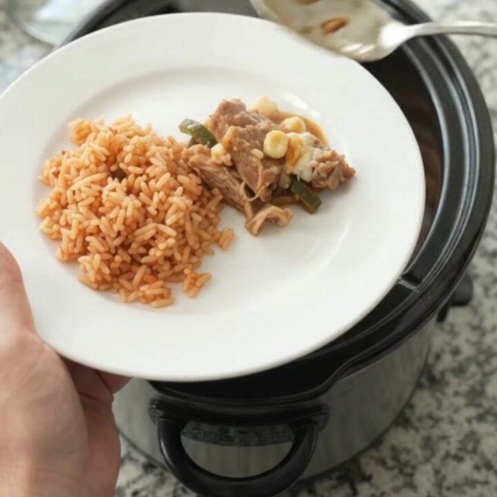 Slow cooker pork carnitas with melted Oaxaca cheese, hominy, and roasted poblanos.