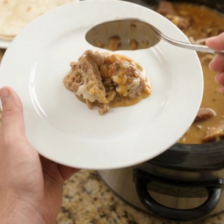 Slow-cooker pork carnitas with pinto beans and melted Monterey Jack cheese