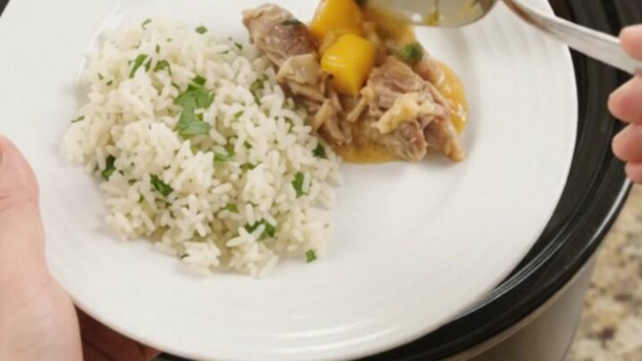 Slow cooker filled with creamy cheddar mango habanero pork carnitas