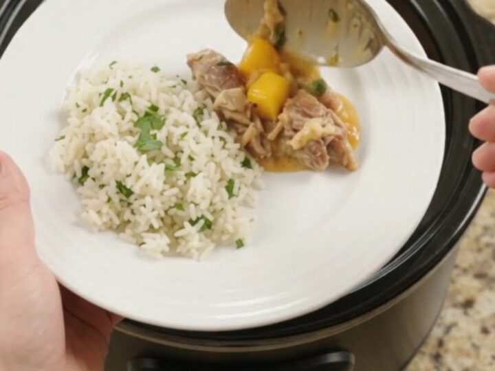 Slow cooker filled with creamy cheddar mango habanero pork carnitas