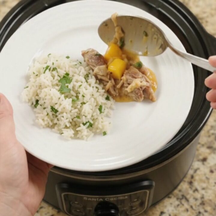 Slow cooker filled with creamy cheddar mango habanero pork carnitas
